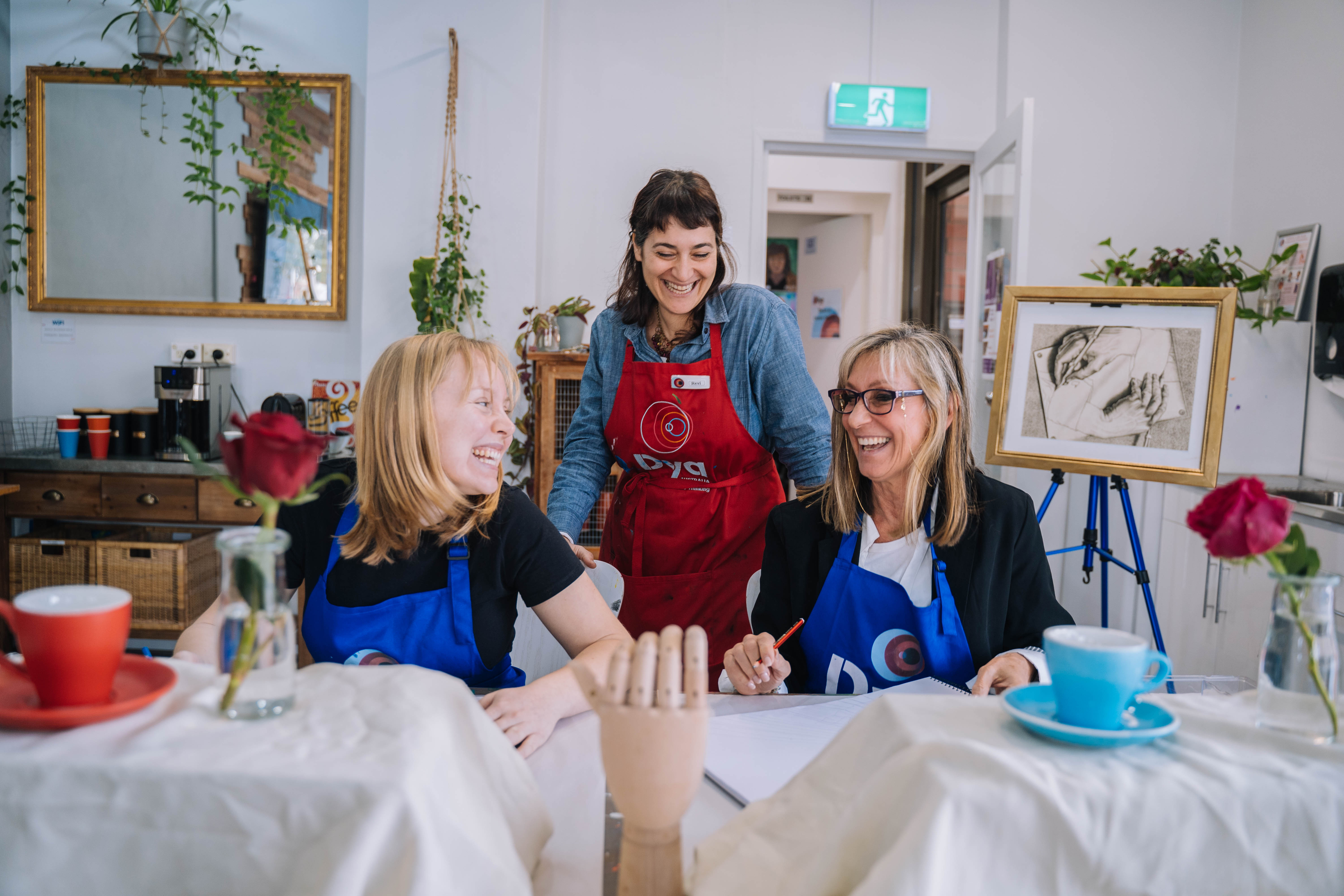 Three women at a painting class